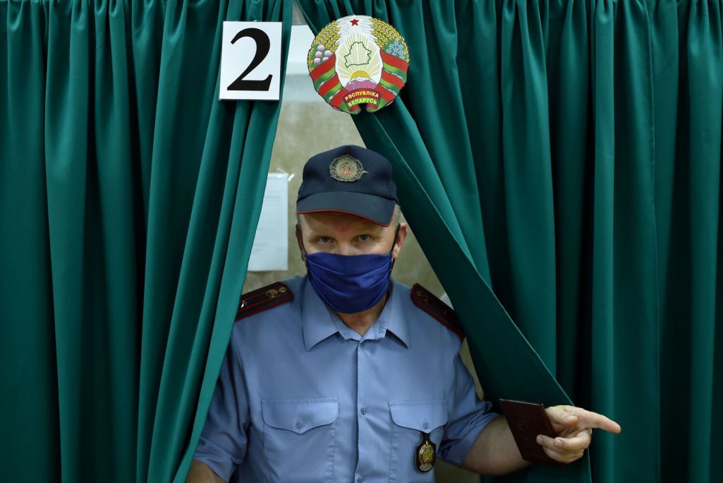 Здымак мае ілюстрацыйны характар. Міліцыянт выходзіць з кабіны падчас датэрміновага галасавання на выбарах прэзідэнта Беларусі ў горадзе Глыбокае, Беларусь. 4 жніўня 2020 года. (Фота: Sergei Gapon / AFP / East News)