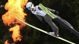 Kacper Tomasiak (fot. Getty Images) Kacper Tomasiak unosi się w powietrzu podczas efektownego skoku. Ubrany w biały kask Uvex i numer startowy z logo Red Bulla, Tomasiak symbolicznie wkracza na wielką scenę — Puchar Świata. Jego narty Fischer przecinają powietrze, a dynamiczne tło podkreśla intensywność emocji towarzyszących debiutowi. To nie tylko sportowy moment, ale wizualna zapowiedź nowego rozdziału w karierze młodego zawodnika, który według Sławomira Hankusa ma wystartować w pierwszych dwunastu konkursach sezonu (fot. Getty Images)